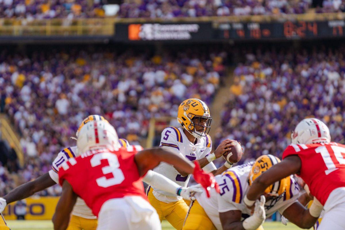 LSU football junior quarterback Jayden Daniels (5) takes the snap on Saturday, Oct. 22, 2022, during LSU&#8217;s 45-20 victory over Ole Miss in Tiger Stadium in Baton Rouge, La.