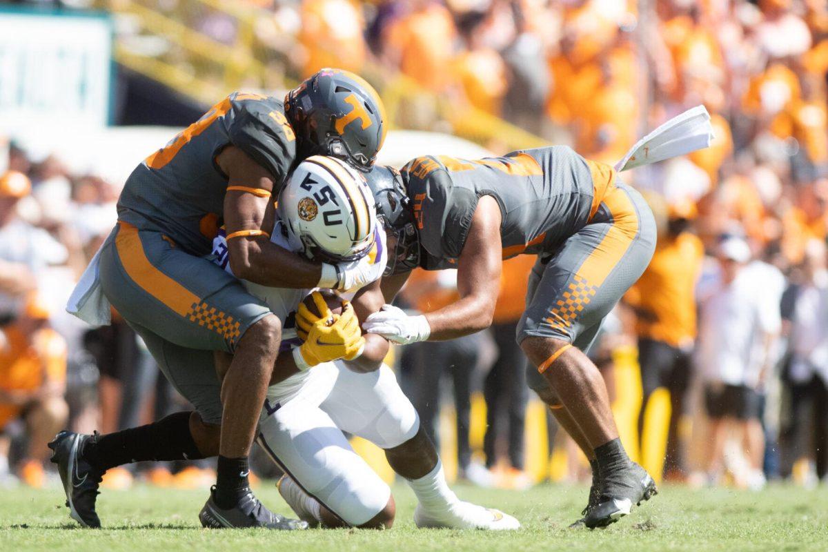 LSU junior running back Noah Cain (21) gets tackled on Saturday, Oct. 8, 2022, during LSU's defeat to Tennessee 13-40 in Tiger Stadium.