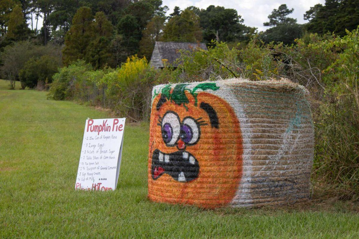 A recipe for pumpkin pie sits beside a bale of hay painted as a pumpkin on Wednesday, Oct. 12, 2022, on Essen Ln. in Baton Rouge, La.