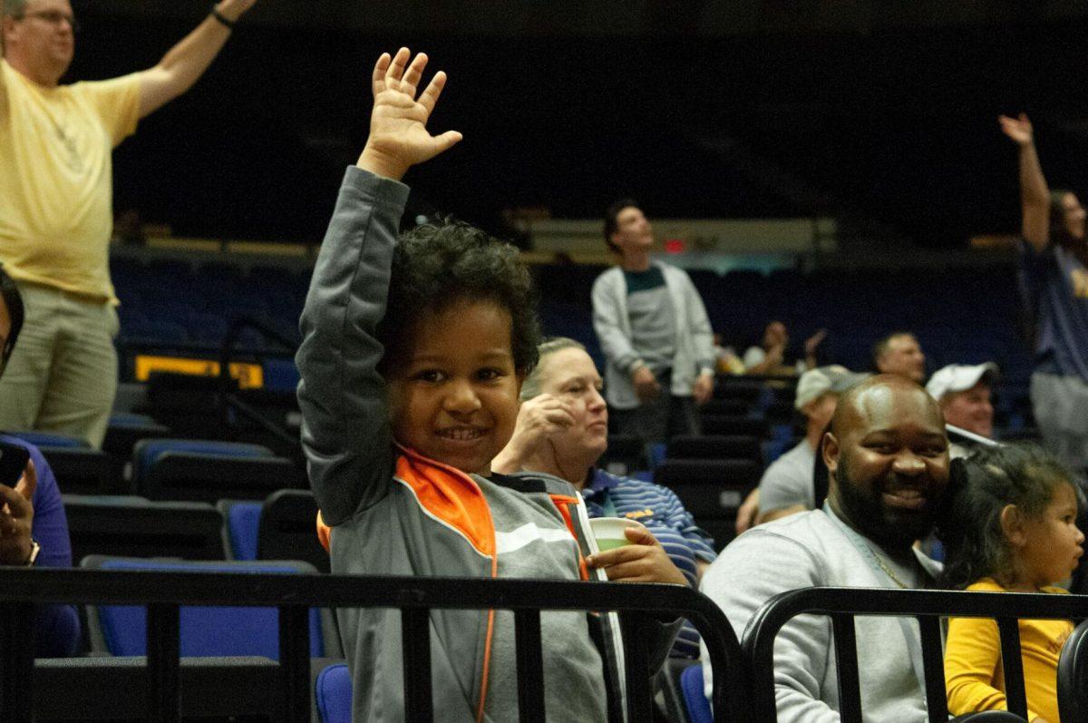 A young fan waves to the camera in hopes of being featured on the big screen at the LSU women's basketball exhibition game against Mississippi College on Thursday, Oct. 27, 2022, in the Pete Maravich Assembly Center on N. Stadium Drive.