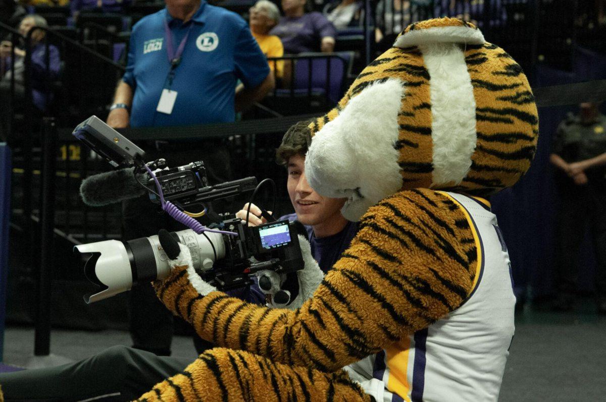 Mike the Tiger learns videography skills from a media staff member at the LSU women's basketball exhibition game against Mississippi College on Thursday, Oct. 27, 2022, in the Pete Maravich Assembly Center on N. Stadium Drive.