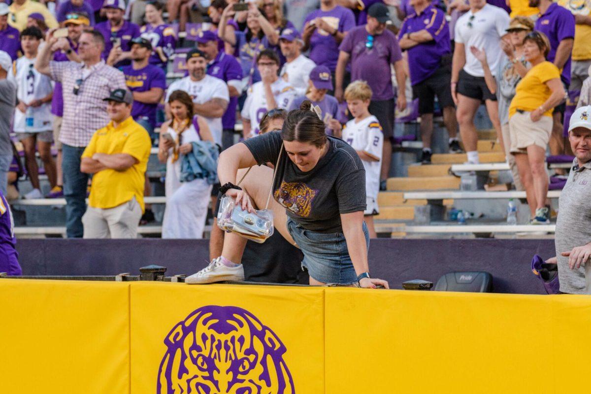 An LSU fans hops over the barrier on Saturday, Oct. 22, 2022, after LSU&#8217;s 45-20 victory over Ole Miss in Tiger Stadium in Baton Rouge, La.