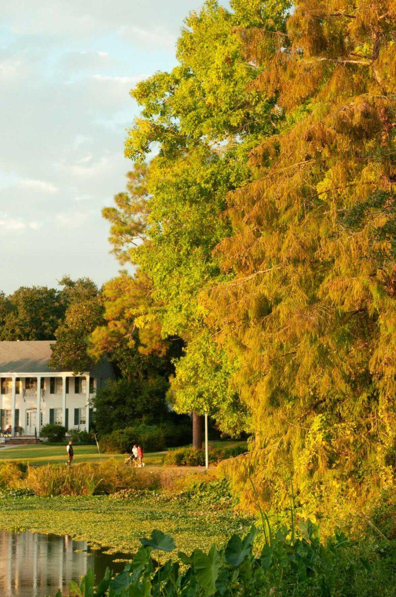 Three people walk around the LSU Lakes on Monday, Oct. 17, 2022, near Milford Wampold Memorial Park in Baton Rouge, La.