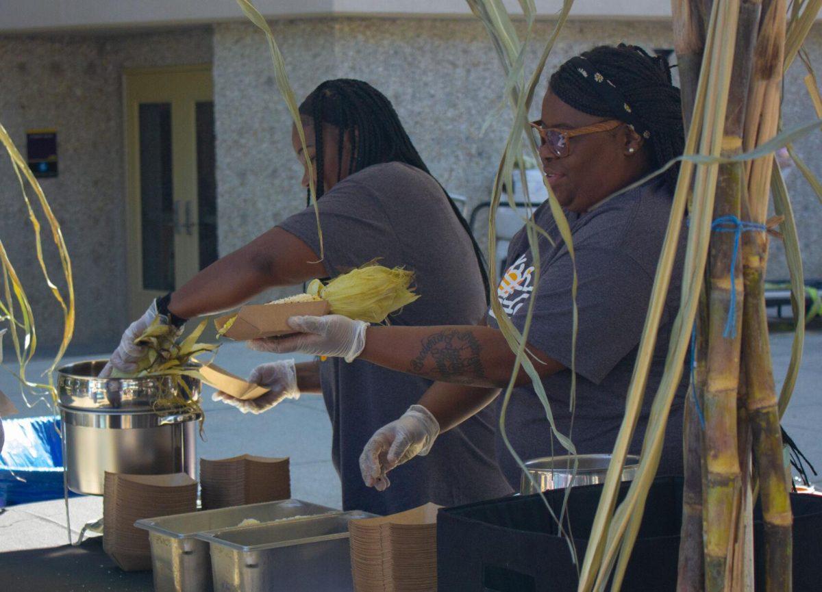 Two women prepare corn for LSU students on Wednesday, Oct. 5, 2022, on Tower Drive in Baton Rouge, La.