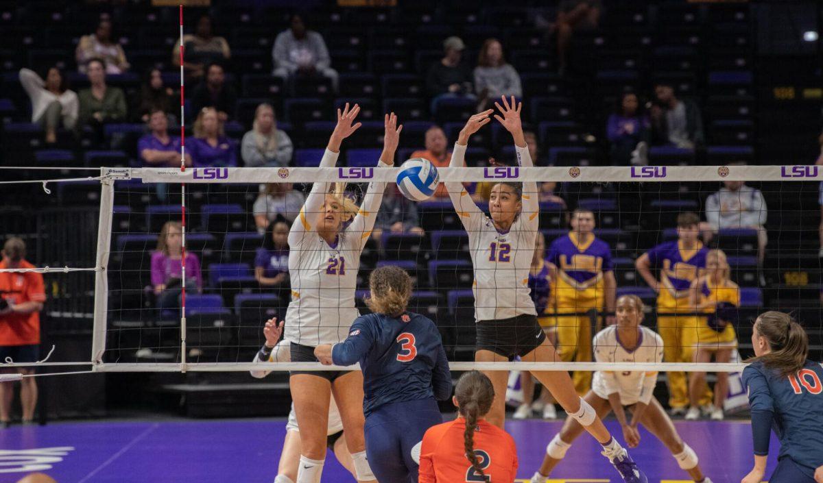 LSU volleyball graduate student right side/outside hitter Hannah Jacobs (21) and LSU volleyball junior middle blocker Alia Williams (12) attempt to block the ball on Wednesday, Oct. 5, 2022, before their 3-2 victory over Auburn in the Pete Maravich Assembly Center on N. Stadium Drive.