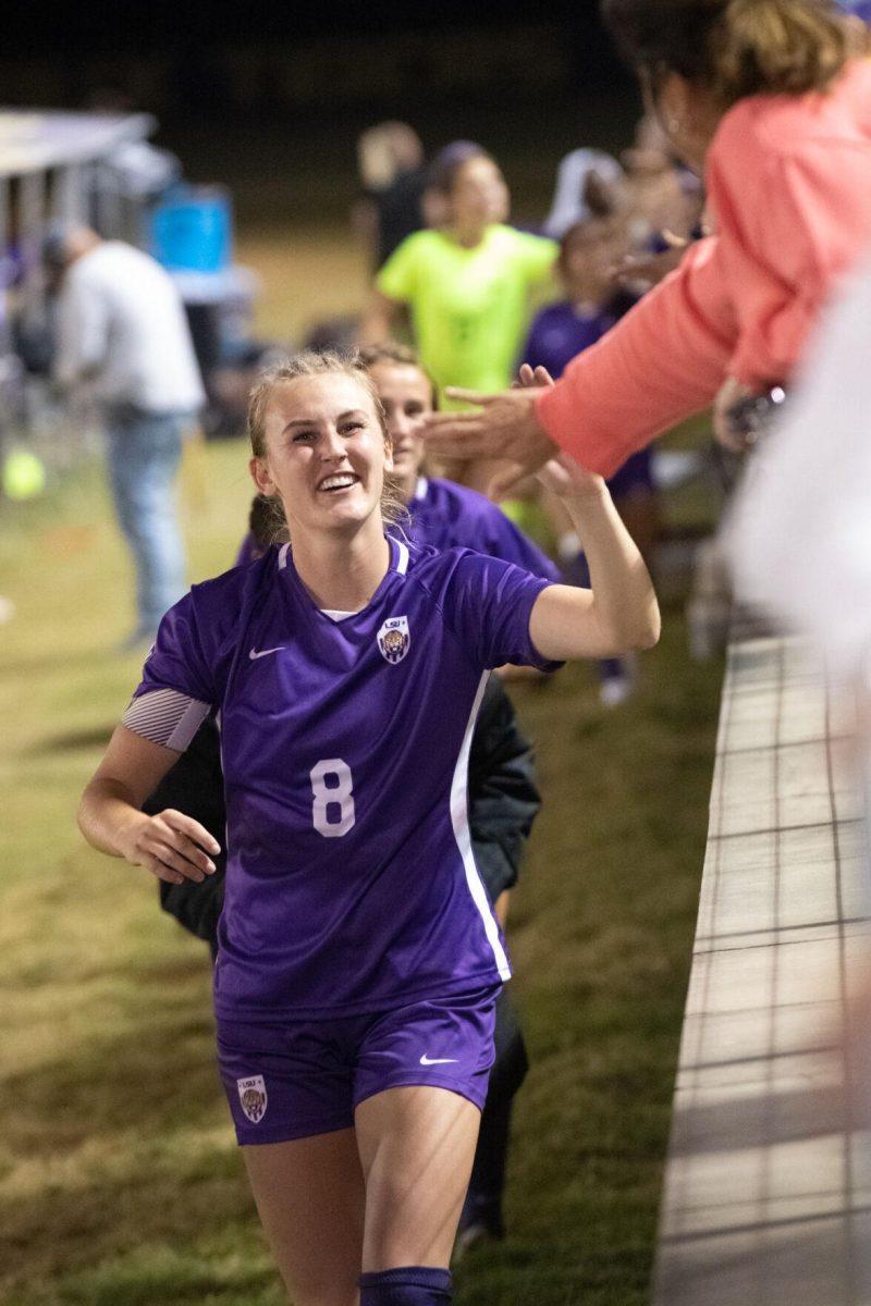 LSU soccer fifth-year senior defender Shannon Cooke (8) gives a high five to a fan on Thursday, Oct. 27, 2022, after LSU&#8217;s 4-1 victory against Ole Miss at LSU&#8217;s Soccer Stadium off of Nicholson Drive.