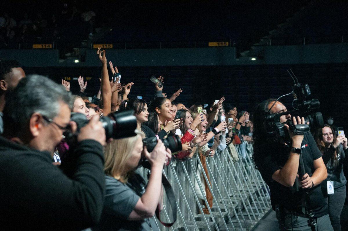 Front-row fans cheer for American rapper Rico Nasty while photographers capture the artist on Wednesday, Oct. 19, 2022, at LSU's homecoming concert at the PMAC on North Stadium Drive in Baton Rouge, La.