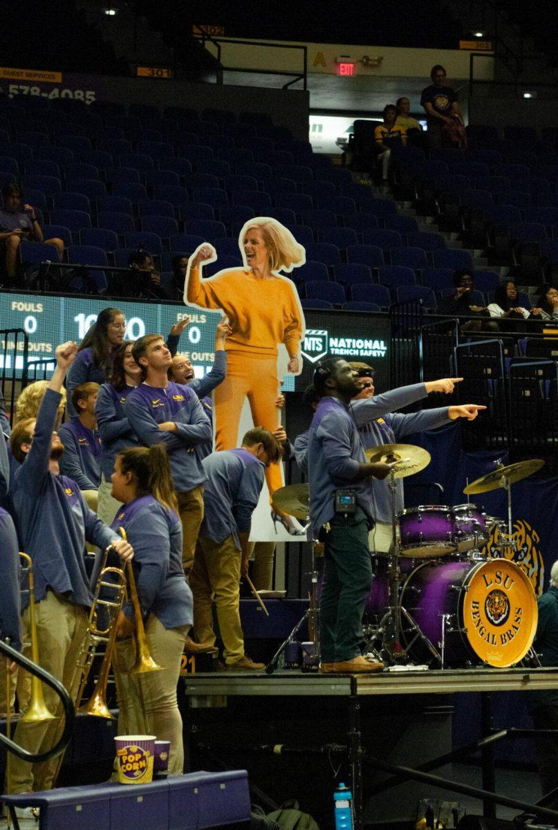 Members of LSU's Bengal Brass band cheer and raise their cardboard cutout of women's basketball head coach Kim Mulkey before the beginning of an exhibition game against Mississippi College on Thursday, Oct. 27, 2022, in the Pete Maravich Assembly Center on N. Stadium Drive.