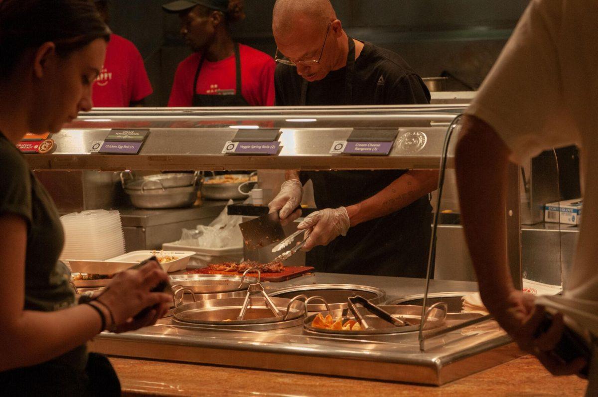 A Panda Express employee chops meat for an order on Thursday, Oct. 6, 2022, in the LSU Student Union on Highland Road in Baton Rouge, La.