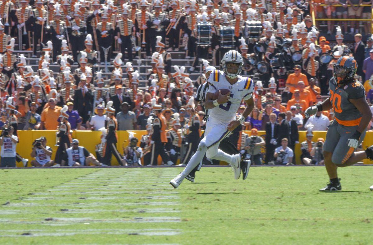 LSU football junior quarterback Jayden Daniels (5) carries the ball down the field on Saturday, Oct. 8, 2022, during Tennessee&#8217;s 40-13 victory over LSU in Tiger Stadium.
