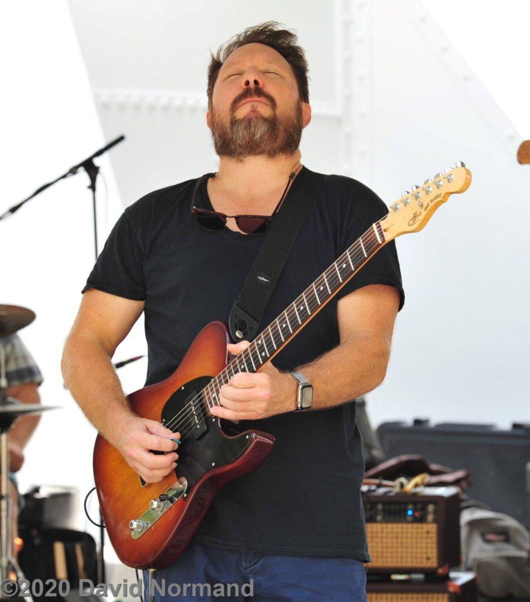 Cam Pyle plays his guitar while performing live.