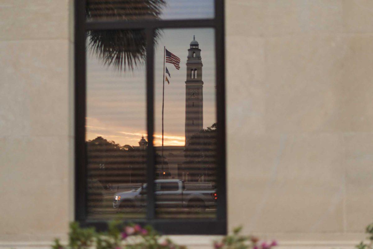 Memorial Tower reflects in a window on Monday, Oct. 17, 2022, at the LSU Law Center on Highland Road in Baton Rouge, La.