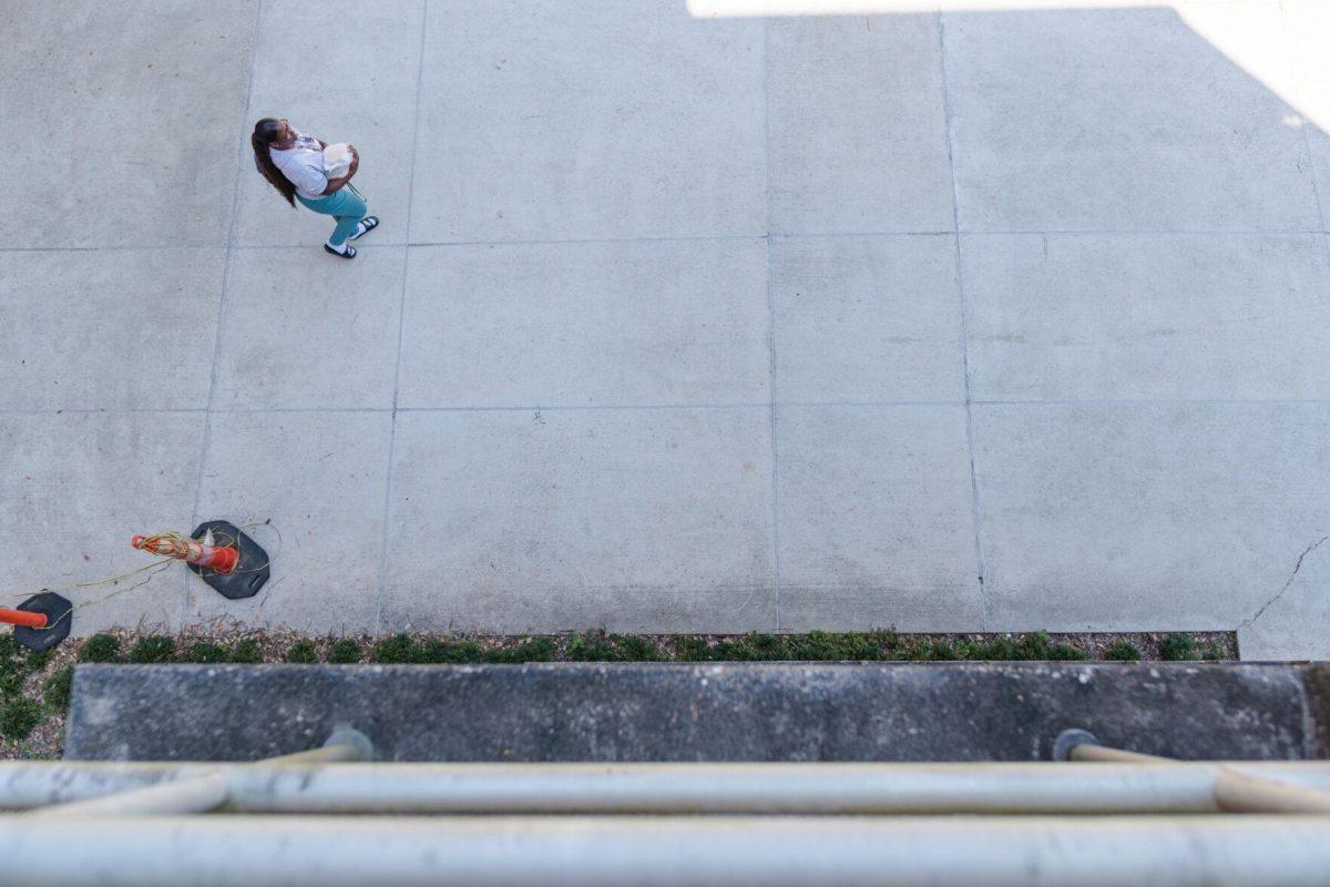 An LSU student carries take-away containers on Friday, Oct. 7, 2022 near the Art and Design building in Baton Rouge, La.