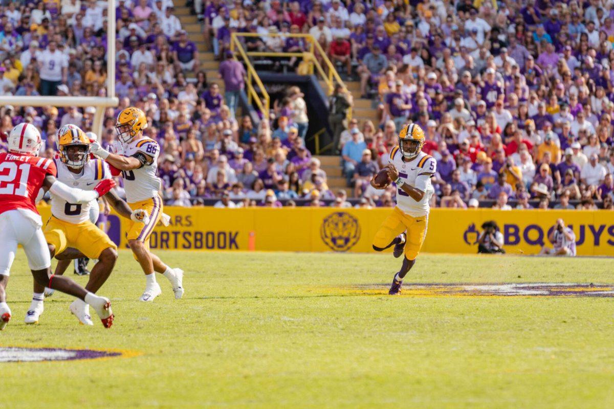 LSU football junior quarterback Jayden Daniels (5) runs with the ball on Saturday, Oct. 22, 2022, during LSU&#8217;s 45-20 victory over Ole Miss in Tiger Stadium in Baton Rouge, La.