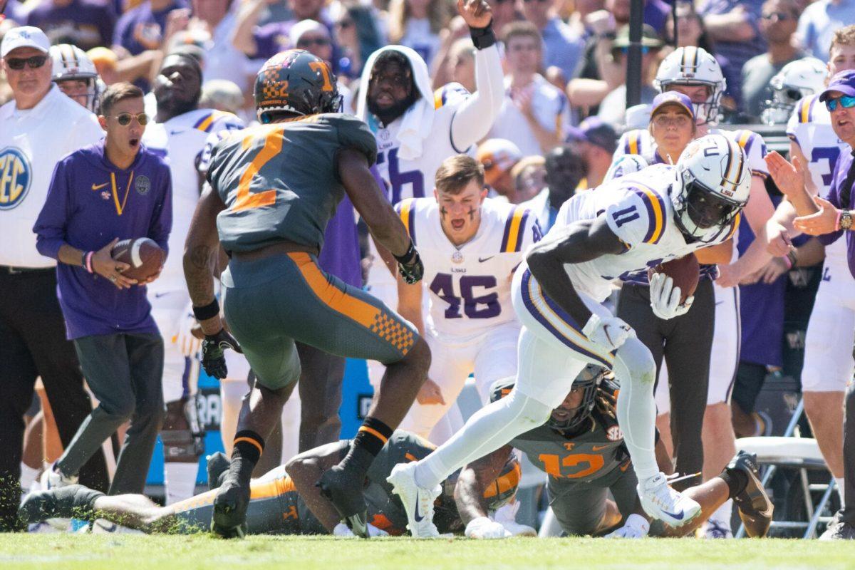 LSU sophomore wide receiver Brian Thomas Jr. (11) avoids a tackle on Saturday, Oct. 8, 2022, during LSU's defeat to Tennessee 13-40 in Tiger Stadium.