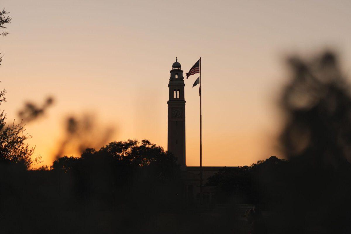 The Sun sets on Saturday, Oct. 8, 2022, behind Memorial Tower on LSU's campus in Baton Rouge, La.