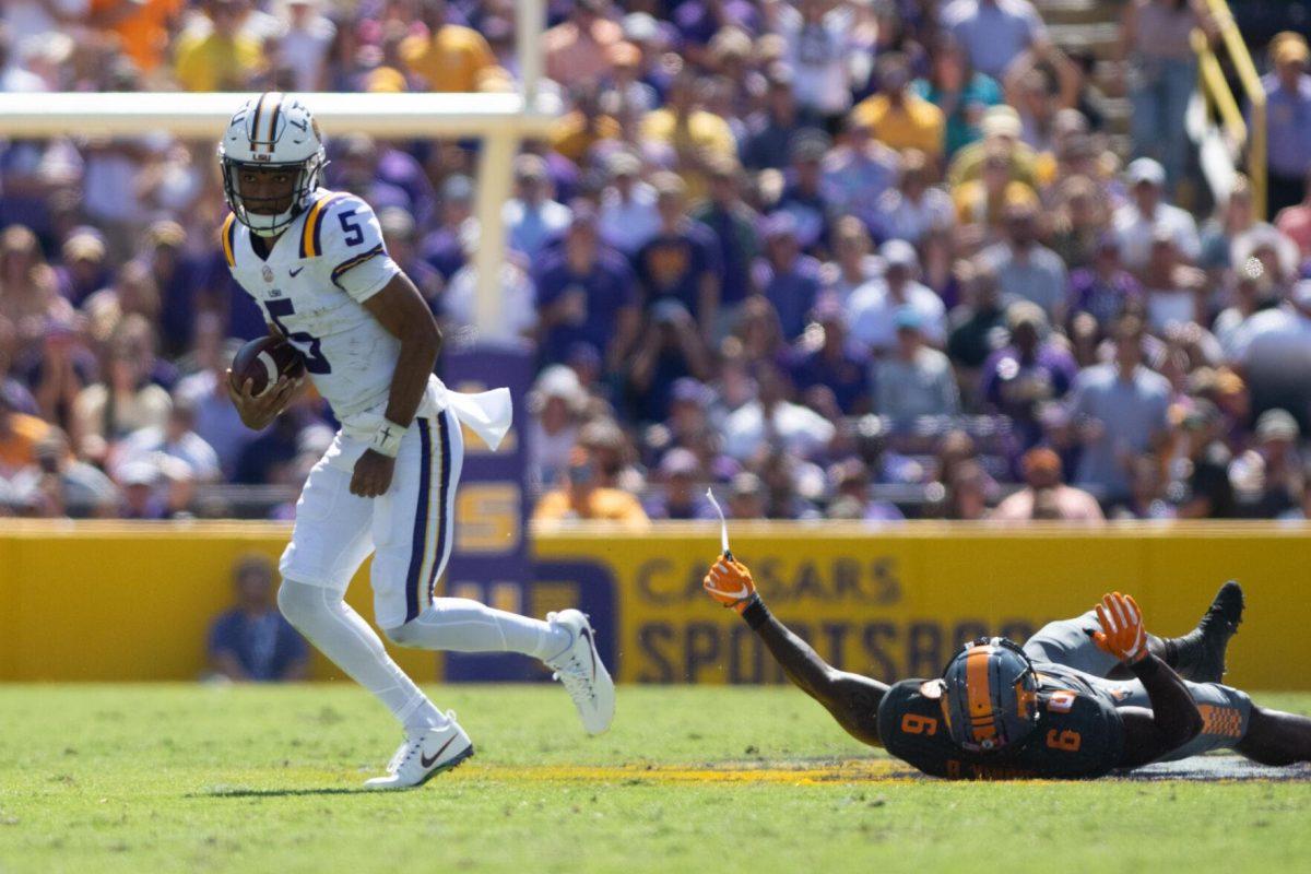 LSU junior quarterback Jayden Daniels (5) avoids a tackle on Saturday, Oct. 8, 2022, during LSU's defeat to Tennessee 13-40 in Tiger Stadium.