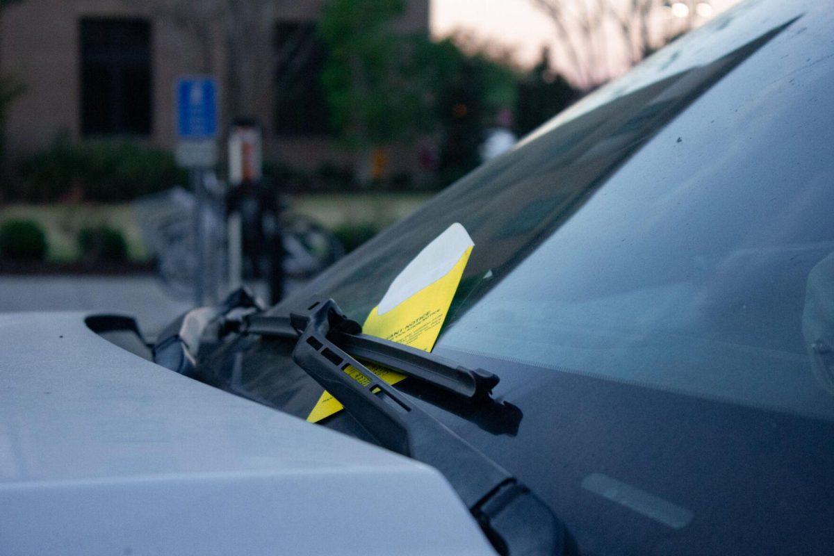 A yellow ticket sits on the car&#8217;s dashboard on Monday, Oct. 3, 2022, near Cypress Hall in Baton Rouge, La.