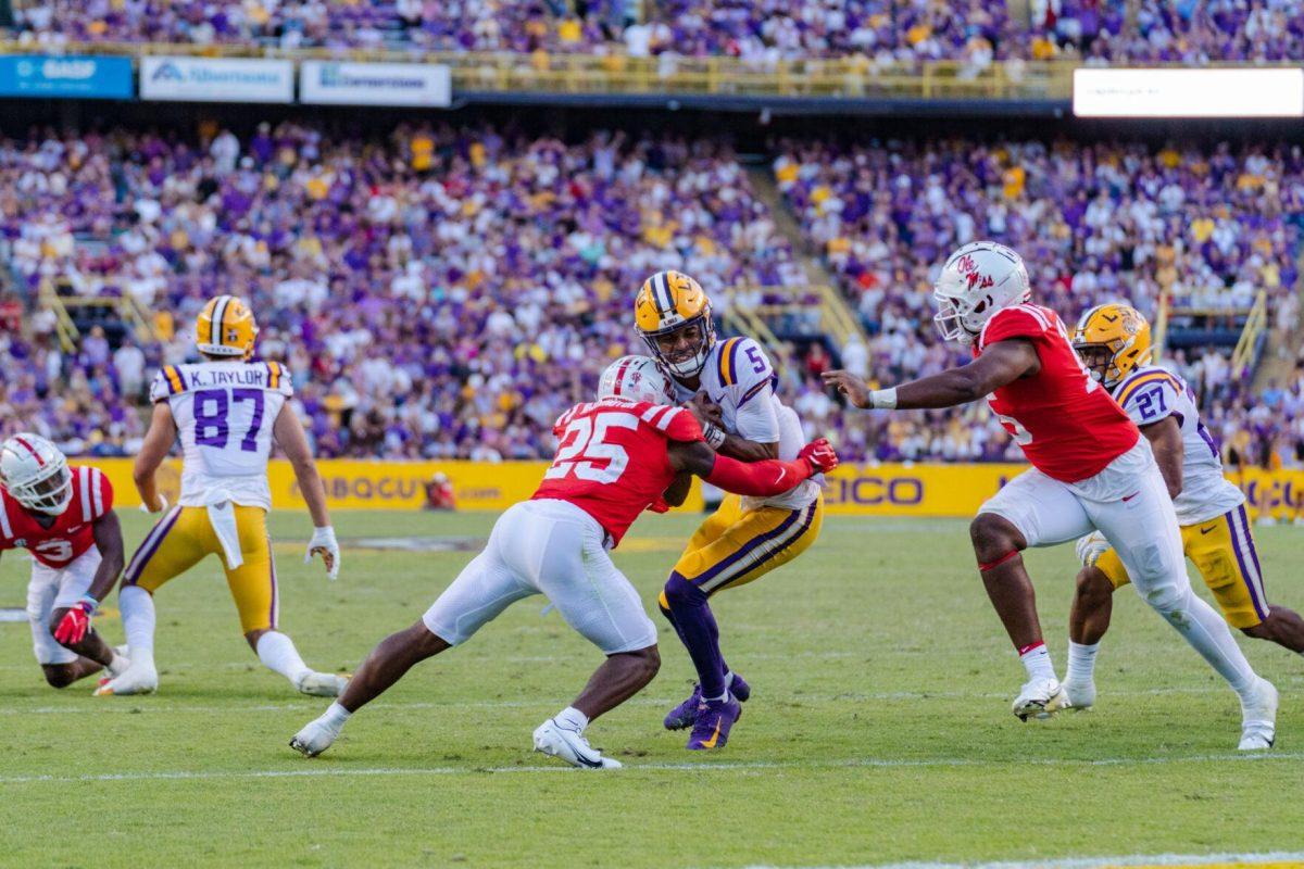 LSU football junior quarterback Jayden Daniels (5) powers down the field on Saturday, Oct. 22, 2022, during LSU&#8217;s 45-20 victory over Ole Miss in Tiger Stadium in Baton Rouge, La.