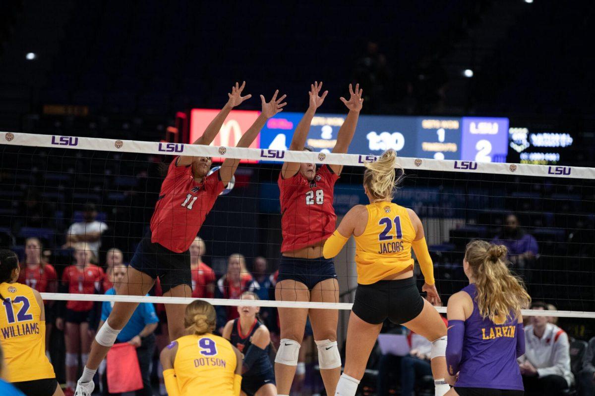 LSU volleyball graduate student Hannah Jacobs (21) hits the ball over the net on Saturday, Oct. 1, 2022, during LSU&#8217;s 2-3 defeat to Ole Miss at the Pete Maravich Assembly Center in Baton Rouge, La.