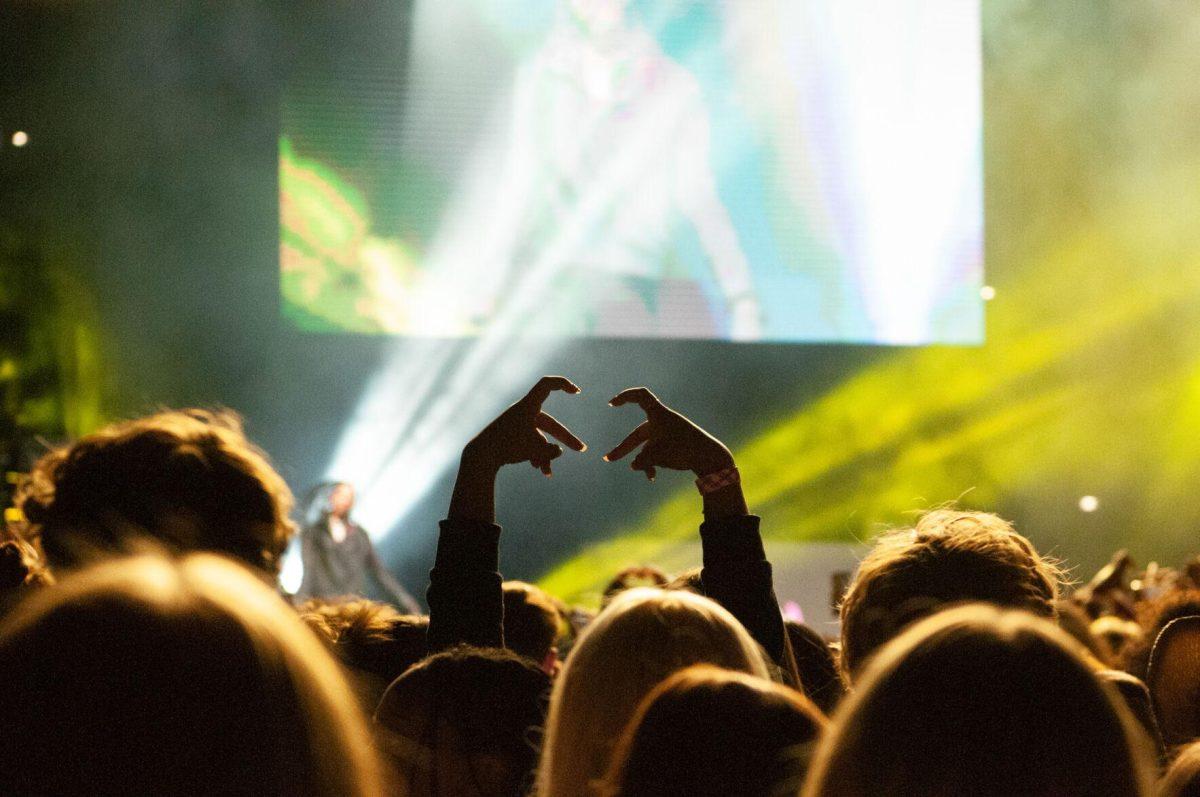 A student in the crowd makes a heart shape with her hands on Wednesday, Oct. 19, 2022, at LSU's homecoming concert at the PMAC on North Stadium Drive in Baton Rouge, La.