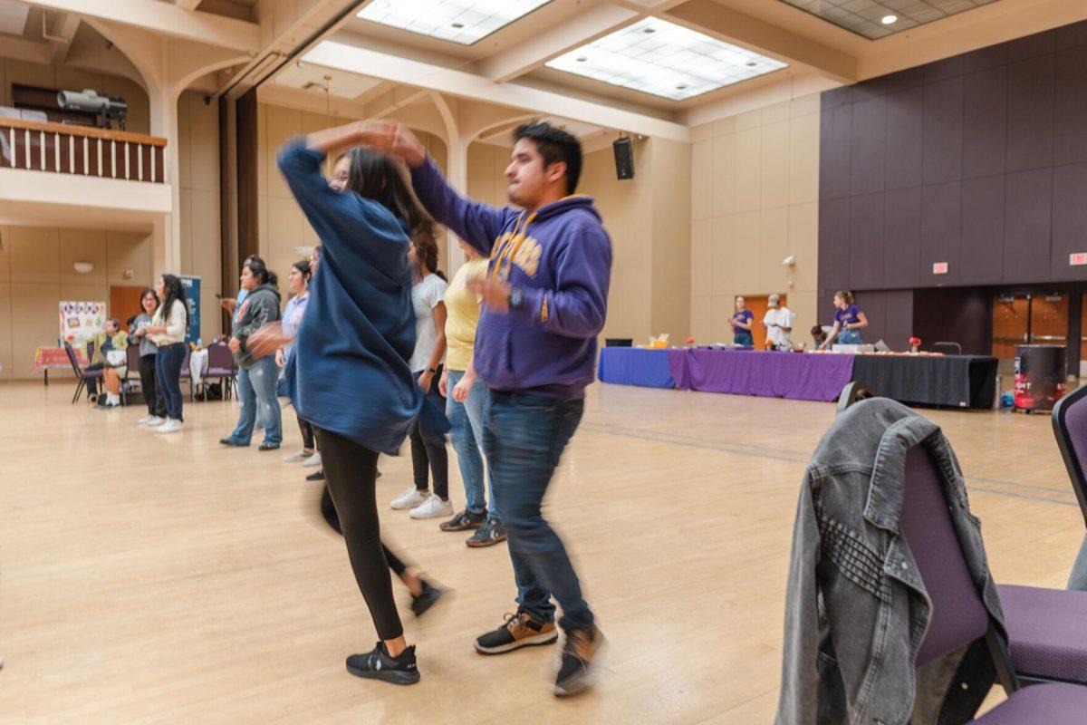 A pair spins during the dance lessons on Friday, Sept. 30, 2022, during Latinx Night at the LSU Union Ballroom.