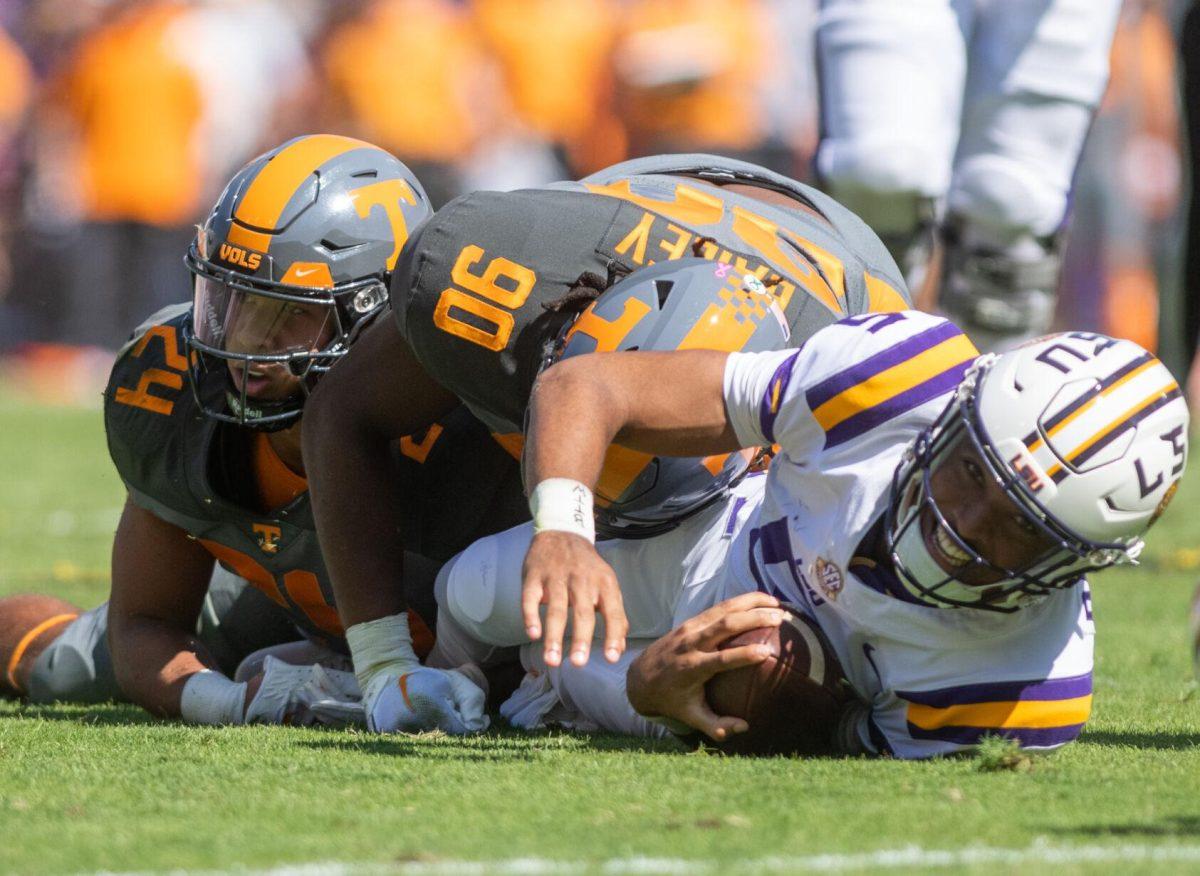 LSU junior quarterback Jayden Daniels (5) is tackled after running the ball on Saturday, Oct. 8, 2022, during LSU's defeat to Tennessee 13-40 in Tiger Stadium.