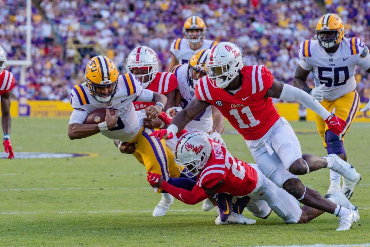 LSU football junior quarterback Jayden Daniels (5) fights for every yard on Saturday, Oct. 22, 2022, during LSU&#8217;s 45-20 victory over Ole Miss in Tiger Stadium in Baton Rouge, La.