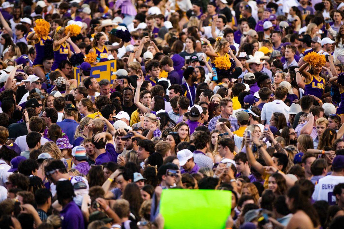 LSU fans storm the football field Saturday, Oct. 22, 2022, after LSU&#8217;s 45-20 win against Ole Miss at Tiger Stadium in Baton Rouge, La.