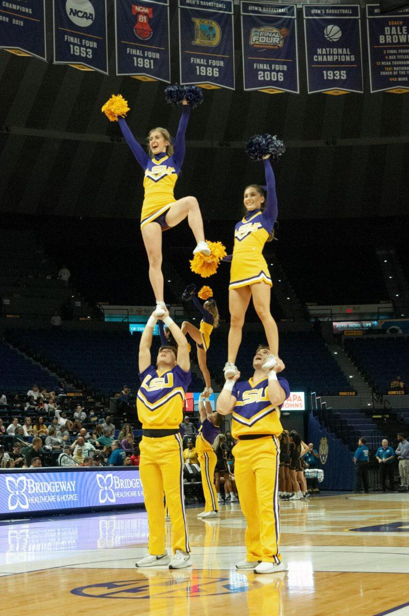 LSU cheerleaders stunt and wave to the crowd at an LSU women's basketball exhibition game against Mississippi College on Thursday, Oct. 27, 2022, in the Pete Maravich Assembly Center on N. Stadium Drive.