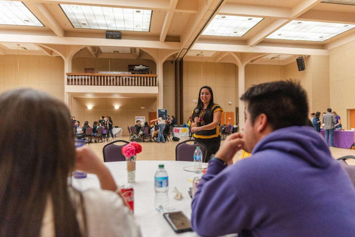 Dr. Alex Torres walks around the room on Friday, Sept. 30, 2022, as she goes over the activities for Latinx Night at the LSU Union Ballroom.