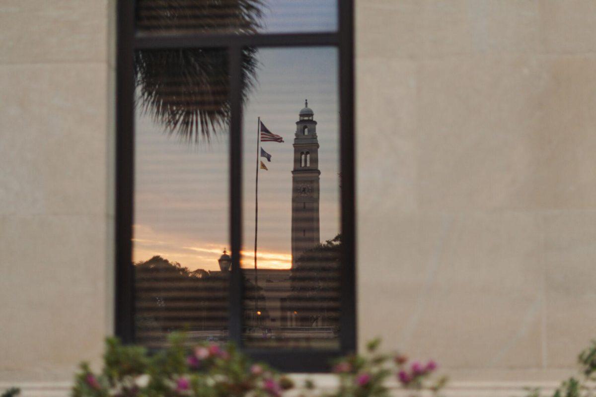 Memorial Tower reflects in a window on Monday, Oct. 17, 2022, at the LSU Law Center on Highland Road in Baton Rouge, La.