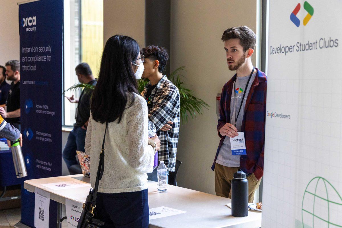 A attendee networks at the Developer Student Clubs table Saturday, Oct. 29, 2022, during DevFest 2022 at the Business Education Complex on LSU's campus.