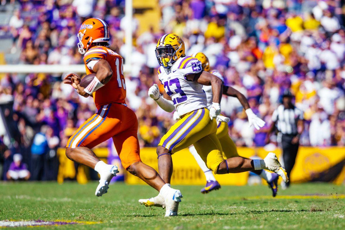 LSU football senior linebacker Micah Baskerville chases Florida redshirt-freshman quarterback Anthony Richardson (15) Saturday, Oct. 16, 2021, during LSU's 49-42 win against Florida at Tiger Stadium in Baton Rouge, La.