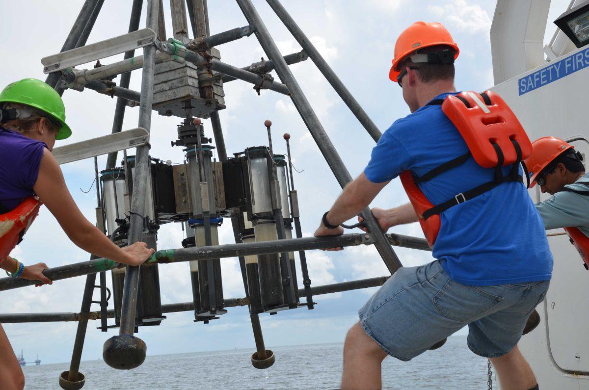 Scientists sample seawater for measurement of dissolved carbon content in coastal Louisiana.