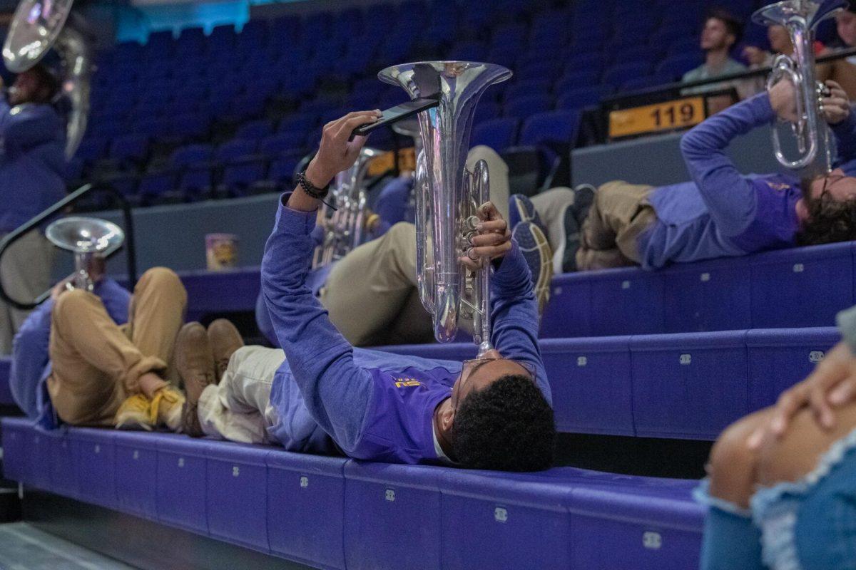 LSU trumpet players lay down as they perform on Wednesday, Oct. 5, 2022, before their 3-2 victory over Auburn in the Pete Maravich Assembly Center on N. Stadium Drive.