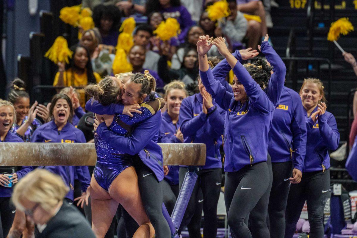 The LSU gymnastics team celebrates a well-done routine on Friday, March 4, 2022, during LSU gymnastics&#8217; 107.500-197.450 loss against Kentucky in the Pete Maravich Assembly Center on North Stadium Drive in Baton Rouge, La.