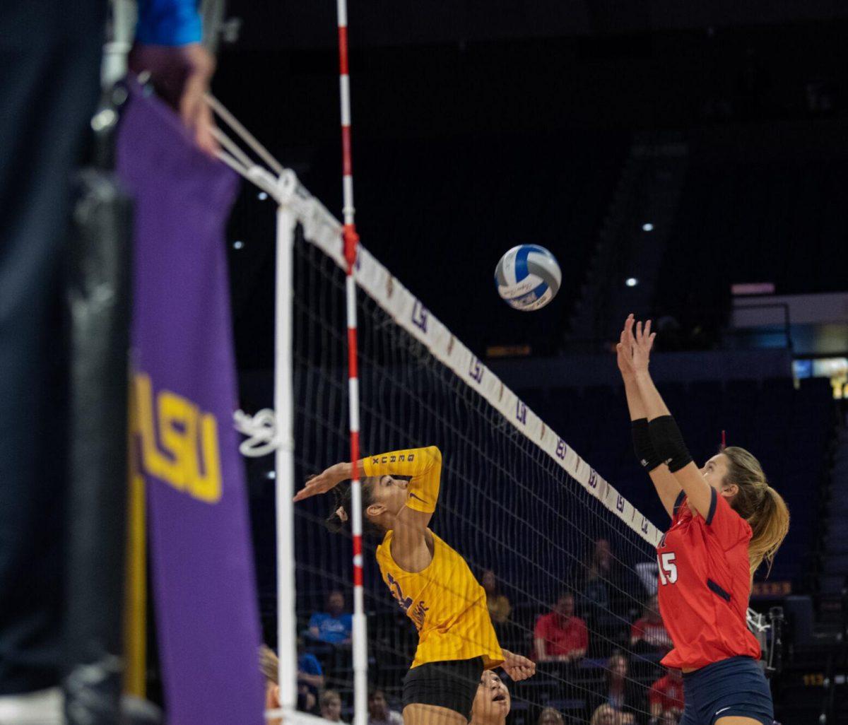 LSU volleyball junior middle blocker Alia Williams (12) jumps up for the ball on Saturday, Oct. 1, 2022, during LSU&#8217;s 2-3 defeat to Ole Miss at the Pete Maravich Assembly Center in Baton Rouge, La.