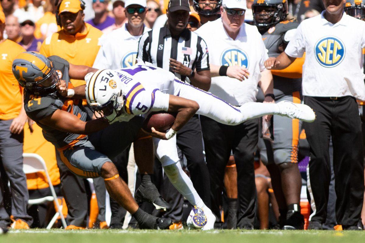 LSU junior quarterback Jayden Daniels (5) gets tackled on Saturday, Oct. 8, 2022, during LSU's defeat to Tennessee 13-40 in Tiger Stadium.