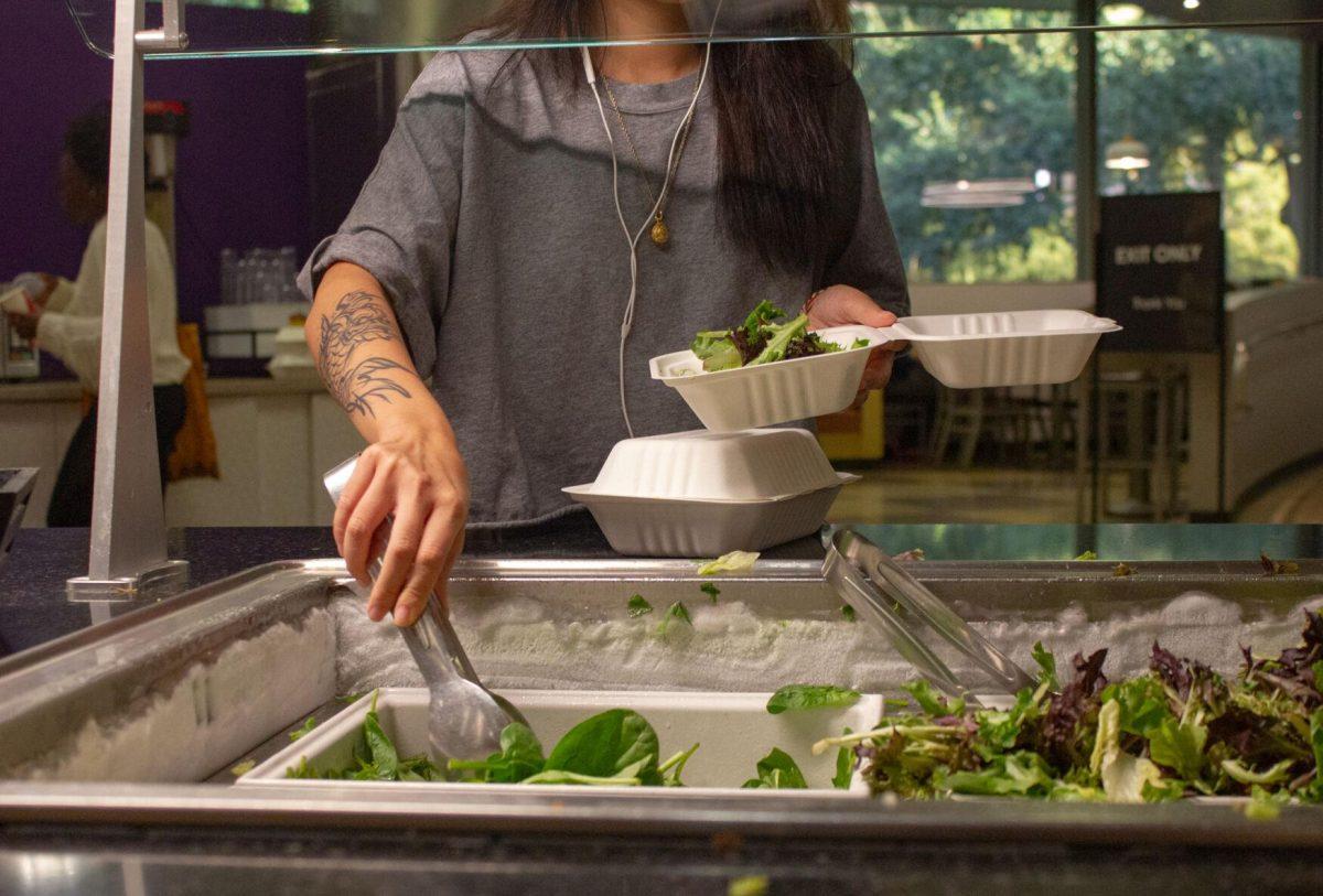 An LSU student fills their box with lettuce on Monday, Oct. 3, 2022, in The 5 Dining Hall in Baton Rouge, La.