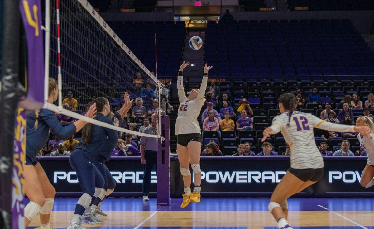 LSU volleyball freshman setter Maddie Waak (22) leaps to set the ball on Wednesday, Oct. 5, 2022, before their 3-2 victory over Auburn in the Pete Maravich Assembly Center on N. Stadium Drive.