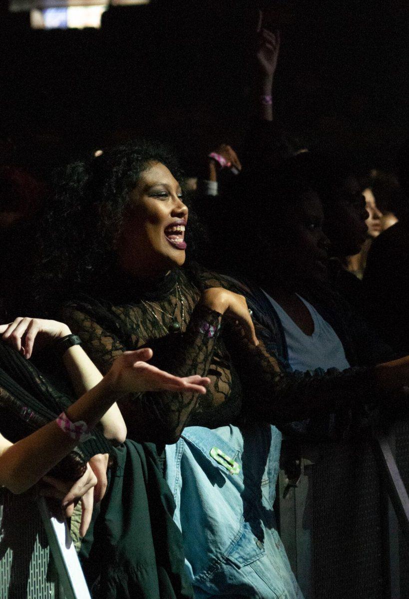 A female student standing in the front row smiles towards the stage on Wednesday, Oct. 19, 2022, at LSU's homecoming concert at the PMAC on North Stadium Drive in Baton Rouge, La.