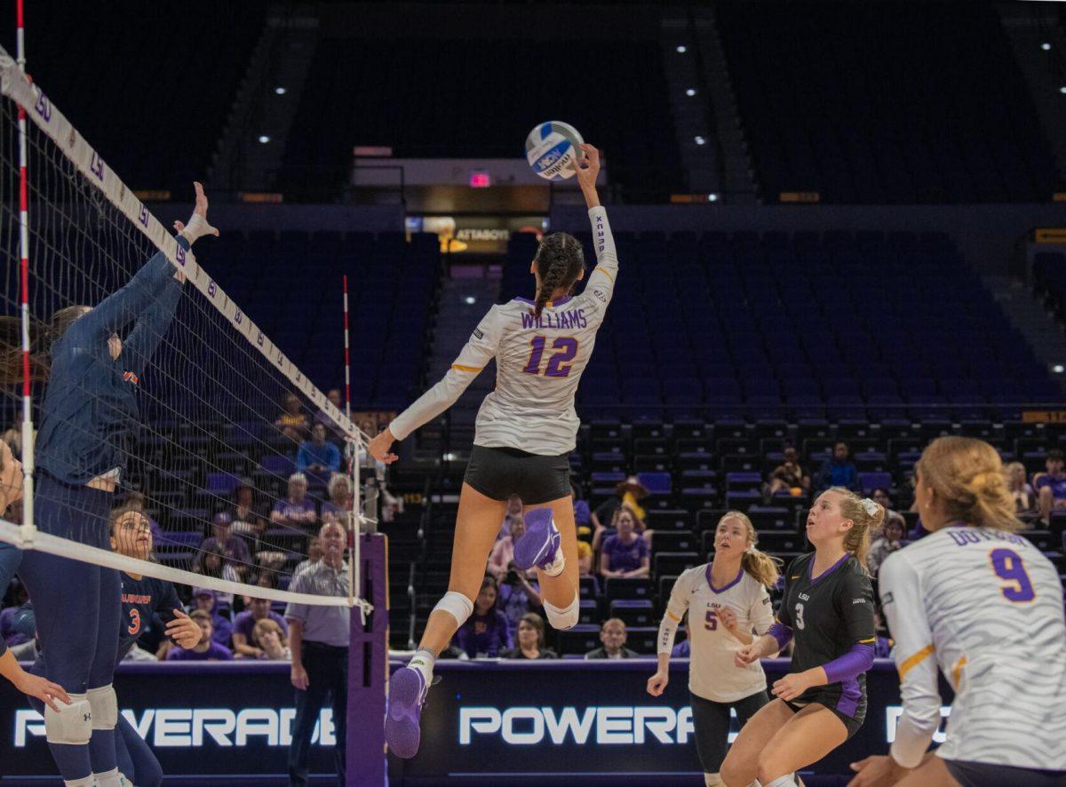 LSU volleyball junior middle blocker Alia Williams (12) leaps into the air to return the ball to Auburn on Wednesday, Oct. 5, 2022, before their 3-2 victory over Auburn in the Pete Maravich Assembly Center on N. Stadium Drive.