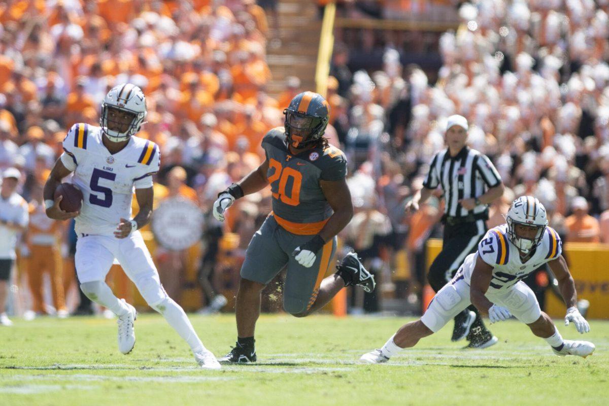 LSU junior quarterback Jayden Daniels (5) avoids a tackle on Saturday, Oct. 8, 2022, during LSU's defeat to Tennessee 13-40 in Tiger Stadium.