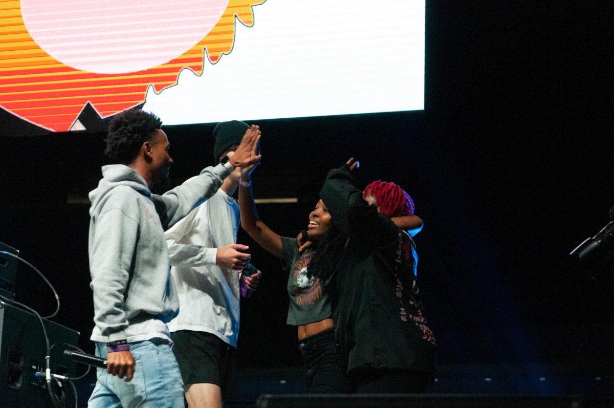 A member of the opening DJ set high-fives two student volunteers that competed in a dance battle on Wednesday, Oct. 19, 2022, at LSU's homecoming concert at the PMAC on North Stadium Drive in Baton Rouge, La.