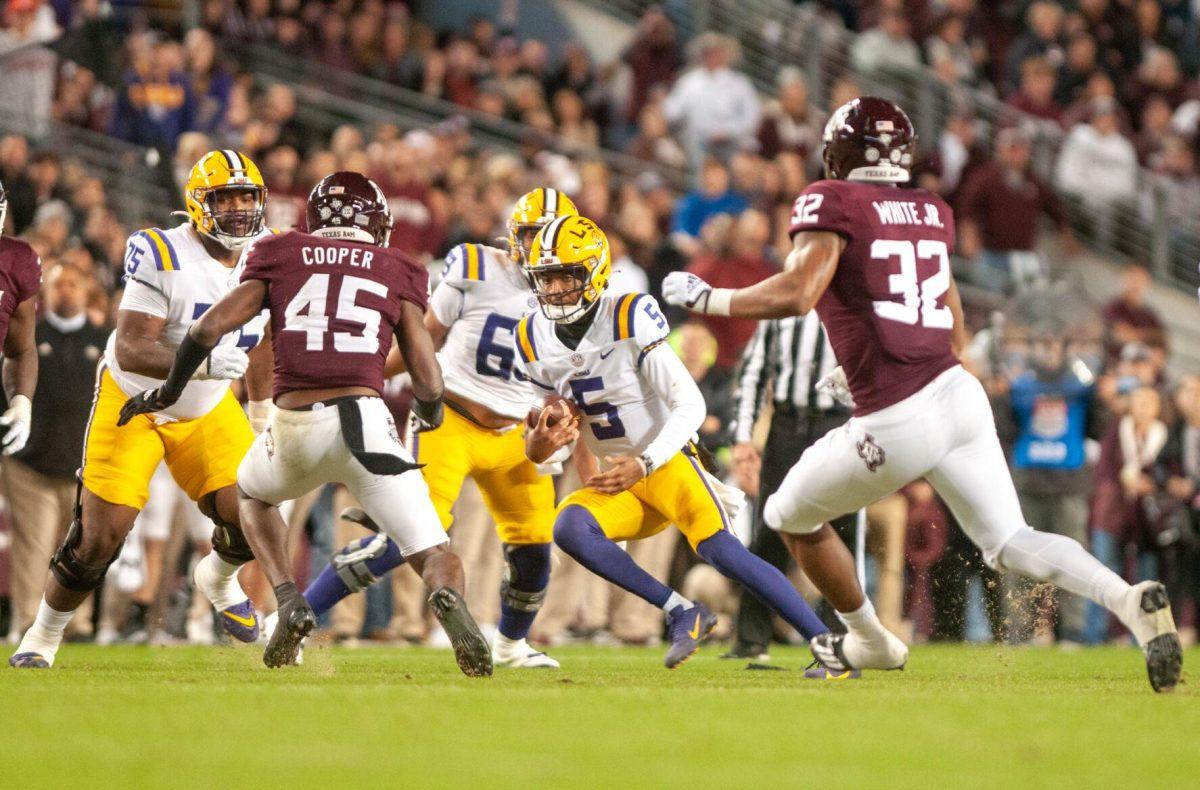 LSU football junior quarterback Jayden Daniels (5) runs the ball on Saturday, Nov. 26, 2022, during LSU's 23-38 loss against Texas A&amp;M at Kyle Field.