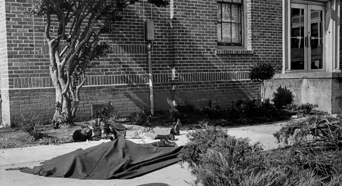 The body of Leonard Brown lay covered on the sidewalk while Denver Smith&#8217;s lay close to the bush in front of the building as authorities waited for ambulances to arrive.