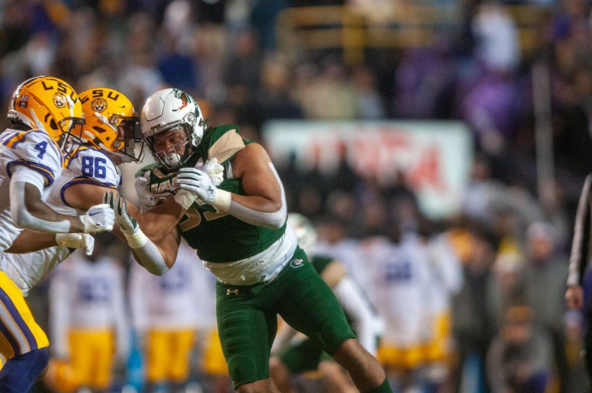 LSU football freshman tight end Mason Taylor (86) and football senior running back John Emery Jr. (4) stop UAB football player on Saturday, Nov. 19, 2022, inside Tiger Stadium in Baton Rouge, La.