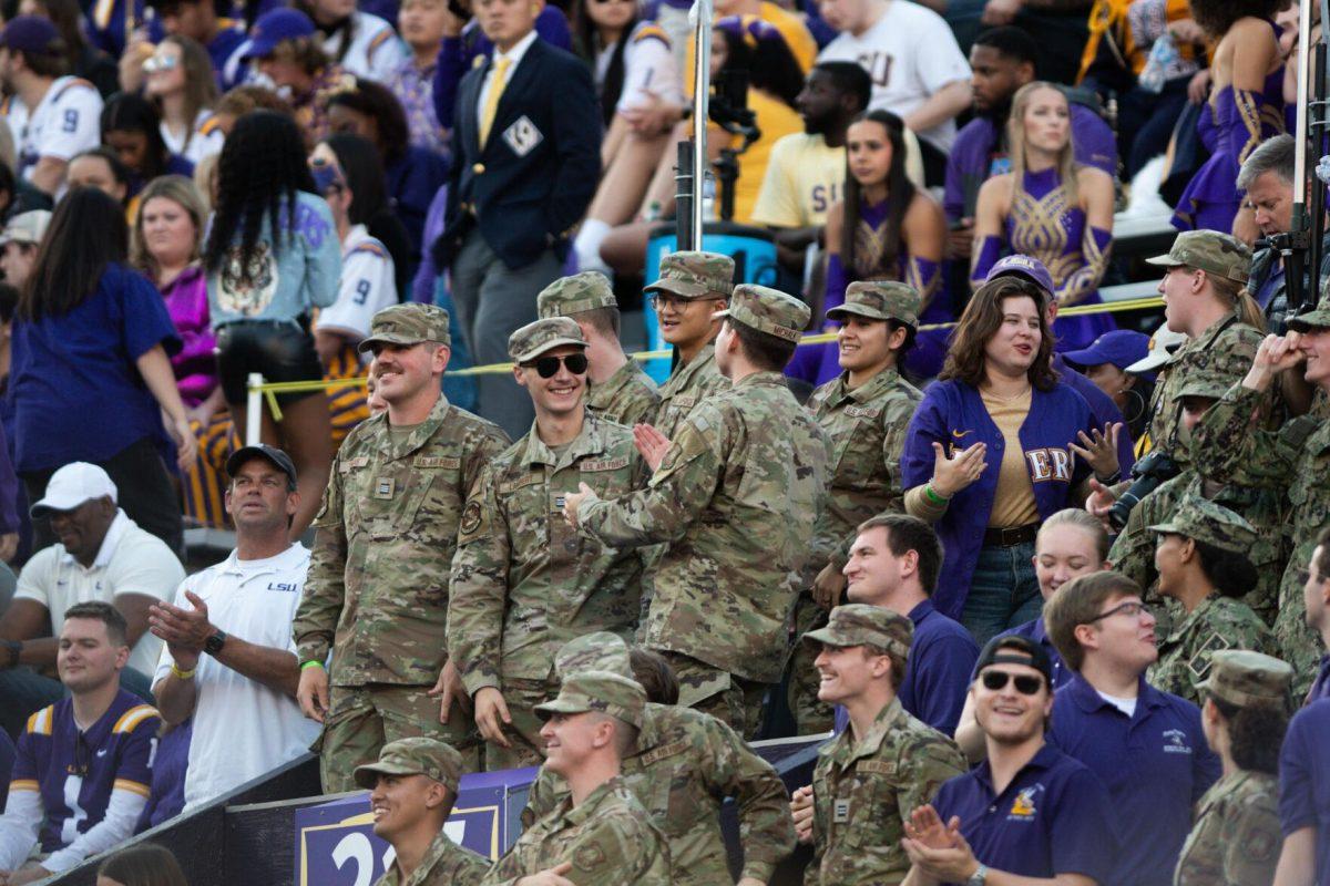 Military officers smile in the student section on Saturday, Nov. 5, 2022, during LSU&#8217;s 32-31 victory over Alabama in Tiger Stadium in Baton Rouge, La.