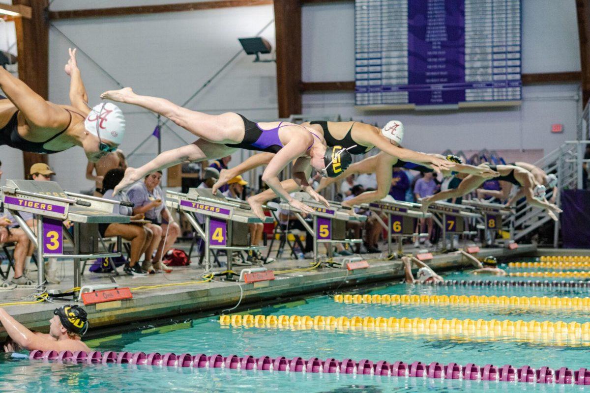 Swimmers dive into the pool on Friday, Nov. 4, 2022, during the LSU women&#8217;s 118-182 loss to Alabama at the LSU natatorium in Baton Rouge, La.